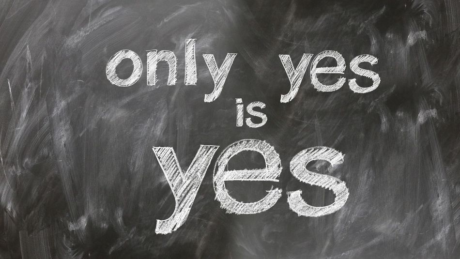 Writing with chalk on blackboard "Only yes is yes"