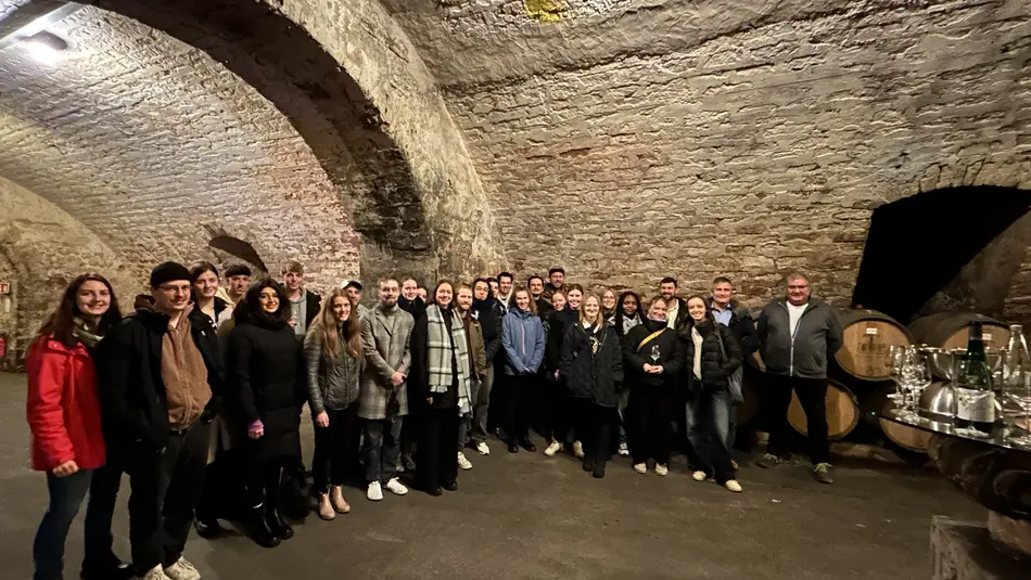 Studierende der Lebensmitteltechnik der Hochschule Trier stehen im Gewölbekeller der Bischöflichen Weingüter Trier