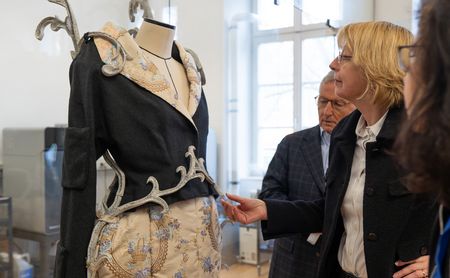 Dr. Manfred Bitter (Vorstandsvorsitzender NKS) und Sabine Plate-Betz (Vorstand NKS) betrachten ein Werk des Studiengangs Modedesign